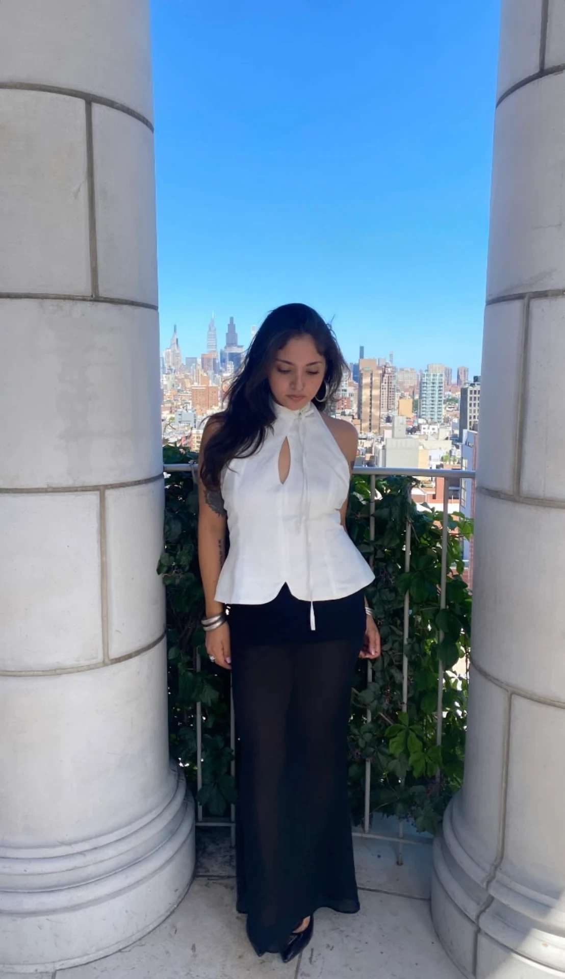 woman wearing the white First Date Top against the New York skyline