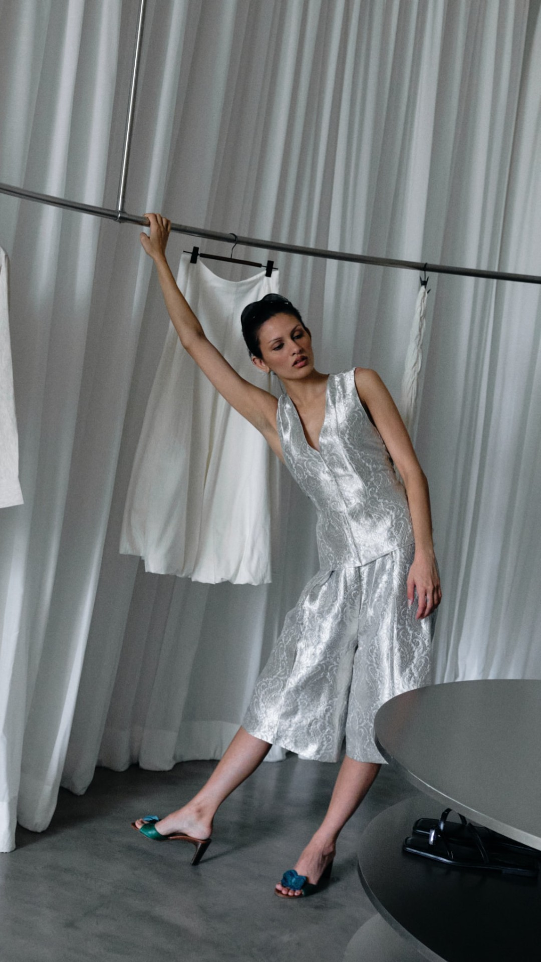 a model in a silver brocade set inside the cult store boutique